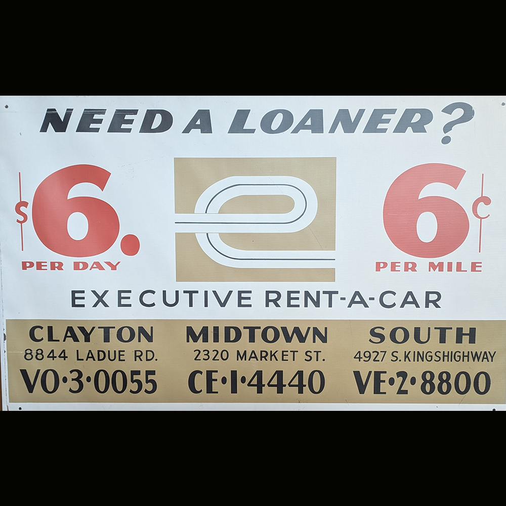  An Executive Rent-A-Car banner promoting loaner vehicles for $6 per day