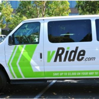 A white Enterprise vRide van with green lettering