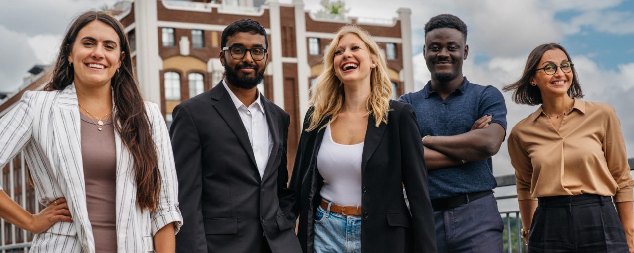 A group shot of five employees, including three women and two men.
