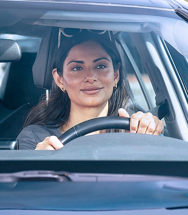 A woman behind the wheel of a vehicle