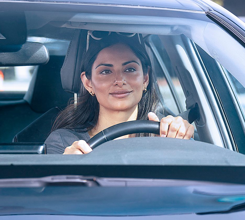 A woman behind the wheel of a vehicle
