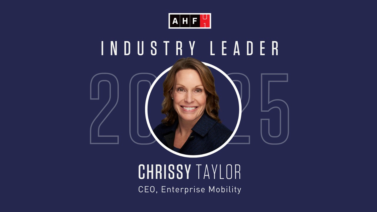 A Chrissy Taylor headshot and graphic on a dark blue background for the Automative Hall of Fame