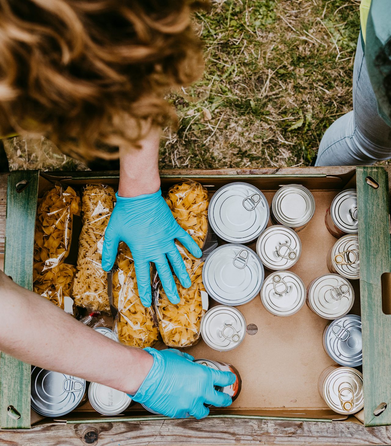 Shot from above of hands with rubber gloves handling food