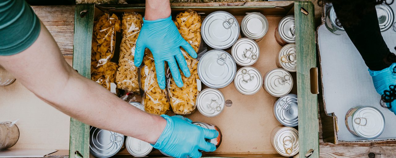Shot from above of hands with rubber gloves handling food